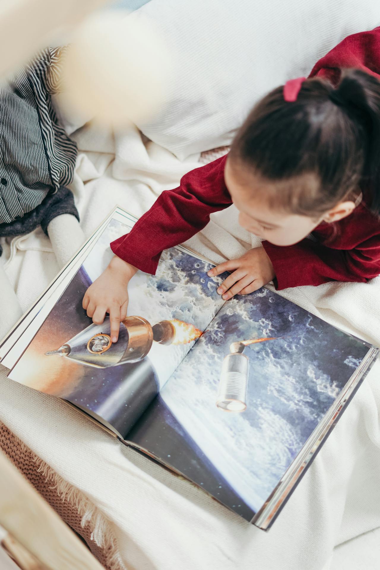 A child focusing on reading a picture book.