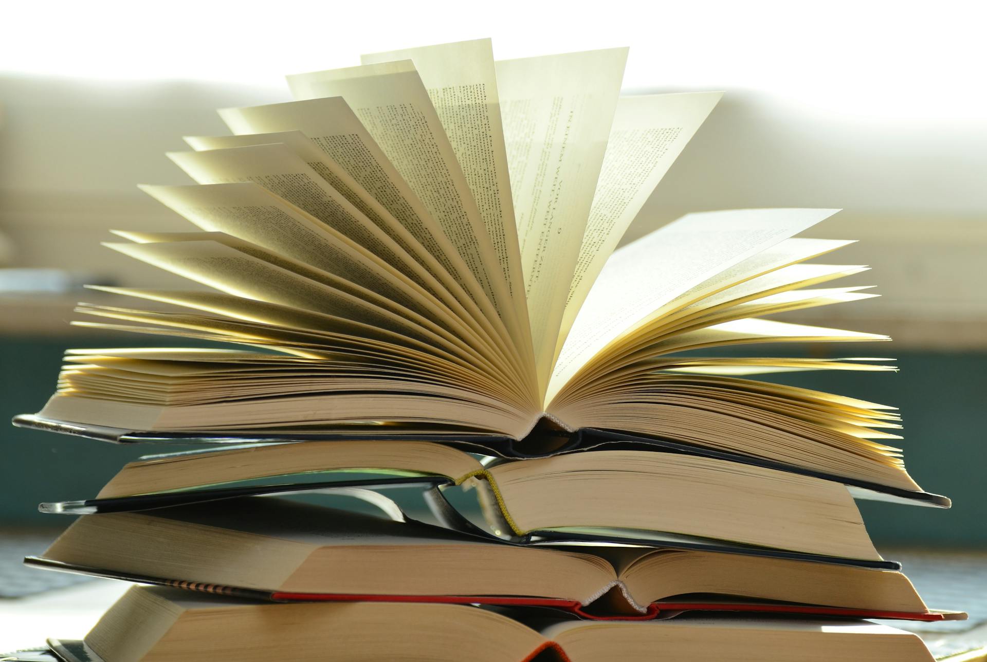 A number of books placed on a desk.