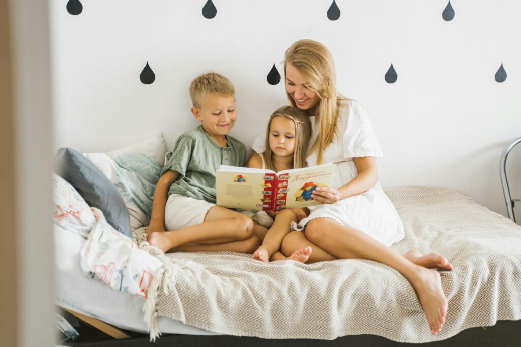 Mother reading a book with two children.